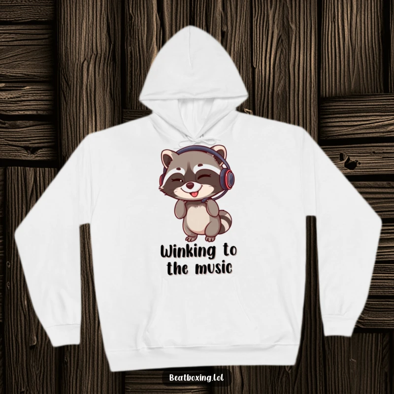 Funny hoodie illustration of a winking raccoon adjusting a headset with a rhythmic grin, a perfect funny gamer gift.